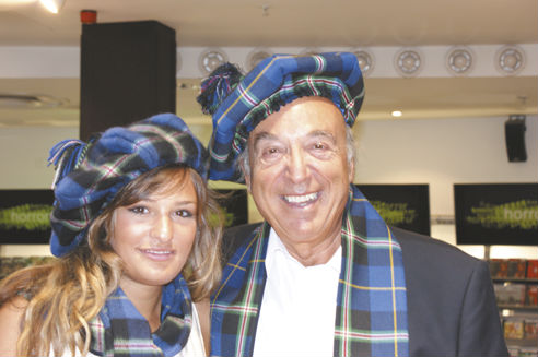 Nicloa Benedetti and her father wearing scarves and bonnets made from the Italian National Tartan presented by Clan Italia